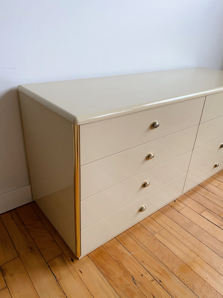 CREAM LACQUERED DRESSER WITH BRASS ACCENTS