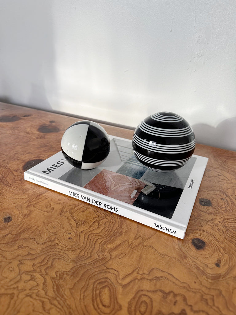 PAIR OF BLACK & WHITE CERAMIC SPHERES