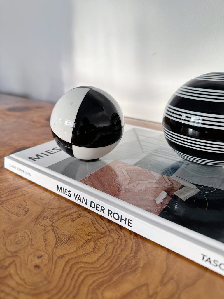 PAIR OF BLACK & WHITE CERAMIC SPHERES